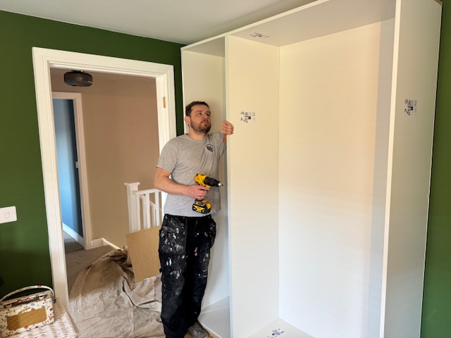 Jonathan and his son installing bespoke fitted wardrobes in Cardiff